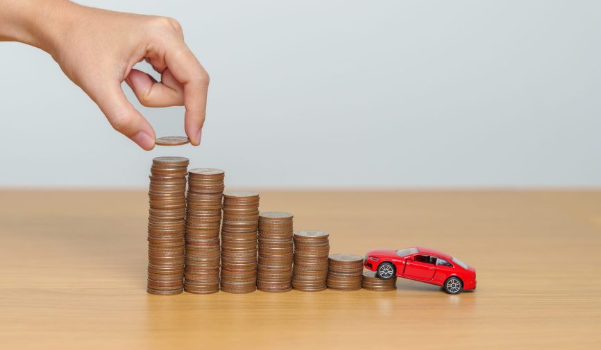 Money Saving, Car Insurance, Financial, vehicle Repair and Maintenance concepts. coins stack and piggy bank with Auto model, Money stack Counting arrangement for deposit and Automobile Tax